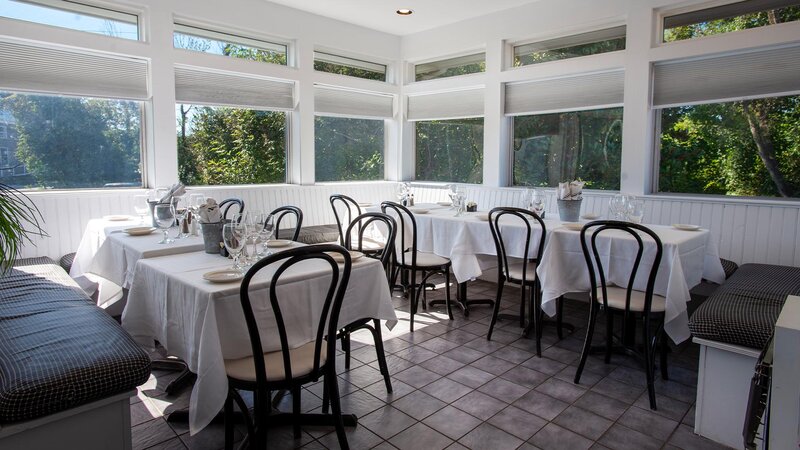 Dining room with set tables and view of the outside