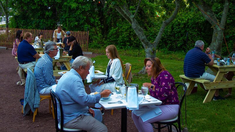Outdoor seating area with guests eating
